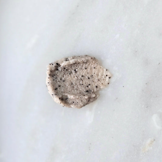 Smear of a sugar and coffee sugar scrub on a marble surface