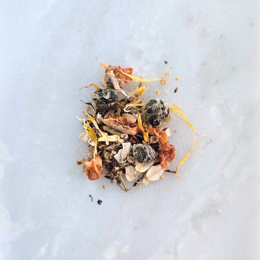 Mixture of dried herbs and flowers on a light gray background