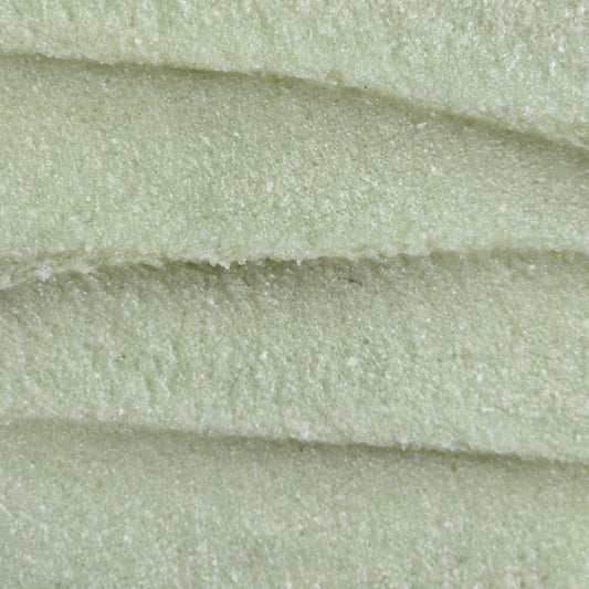 Close up of light green whipped sugar scrub texture
