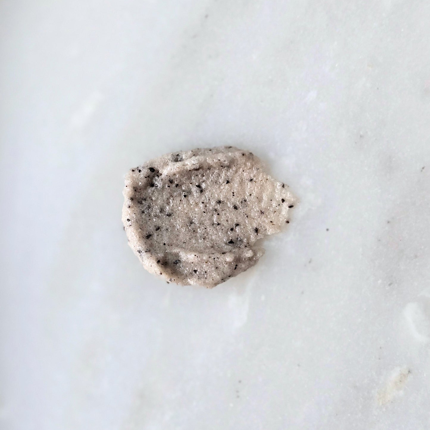 Smear of a sugar and coffee sugar scrub on a marble surface