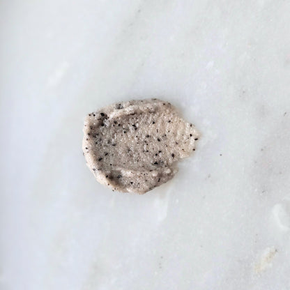 Smear of a sugar and coffee sugar scrub on a marble surface