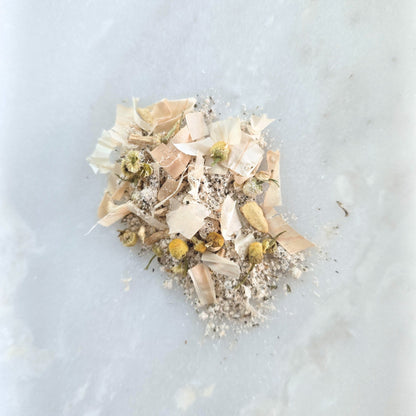 Dried flowers and leaves on a light blue marble surface