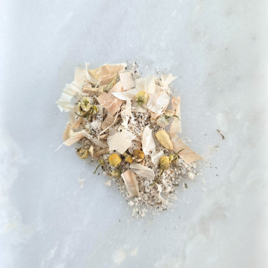 Dried flowers and leaves on a light blue marble surface