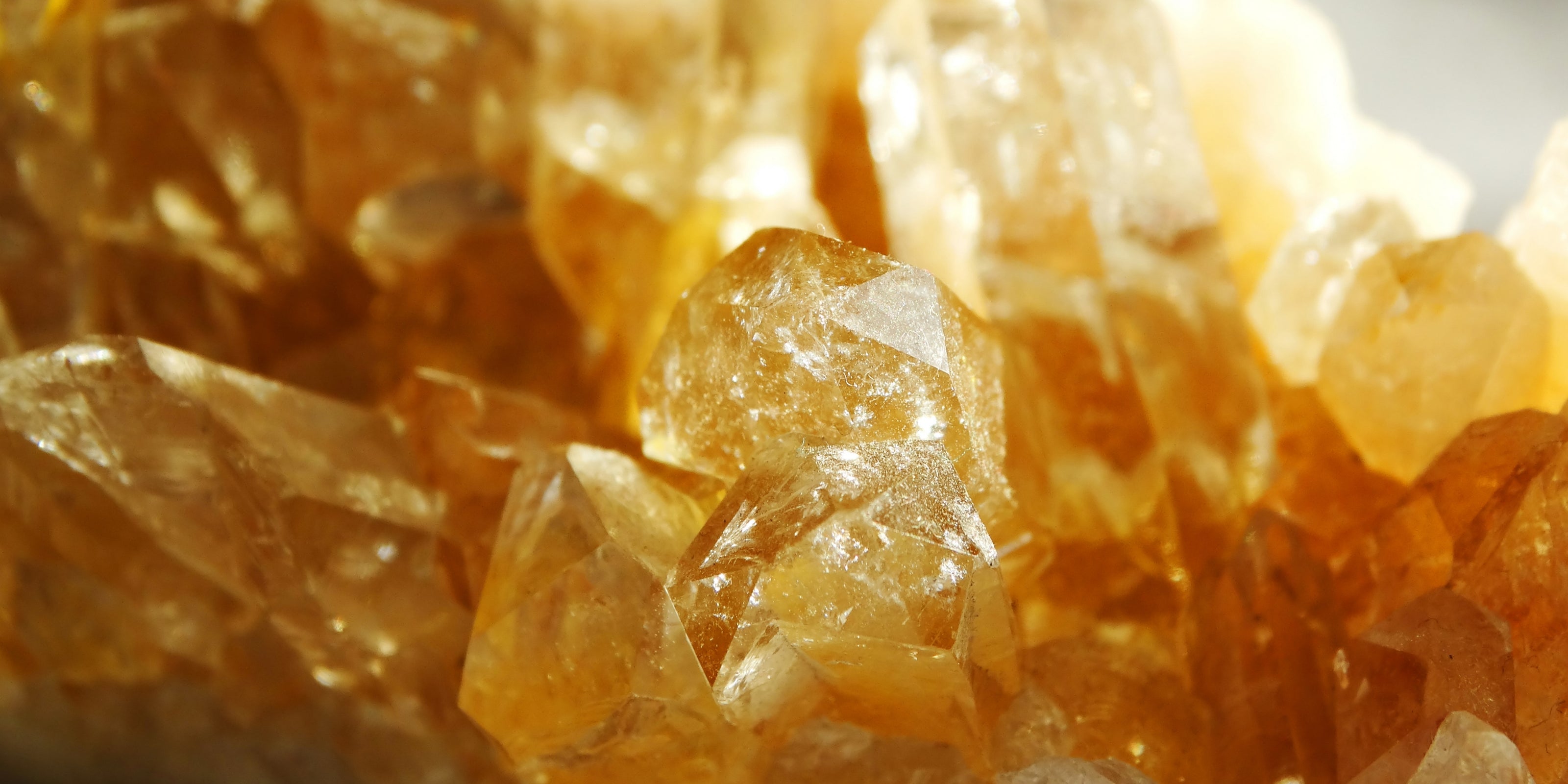 Close-up of amber-colored citrine gemstone crystal formations