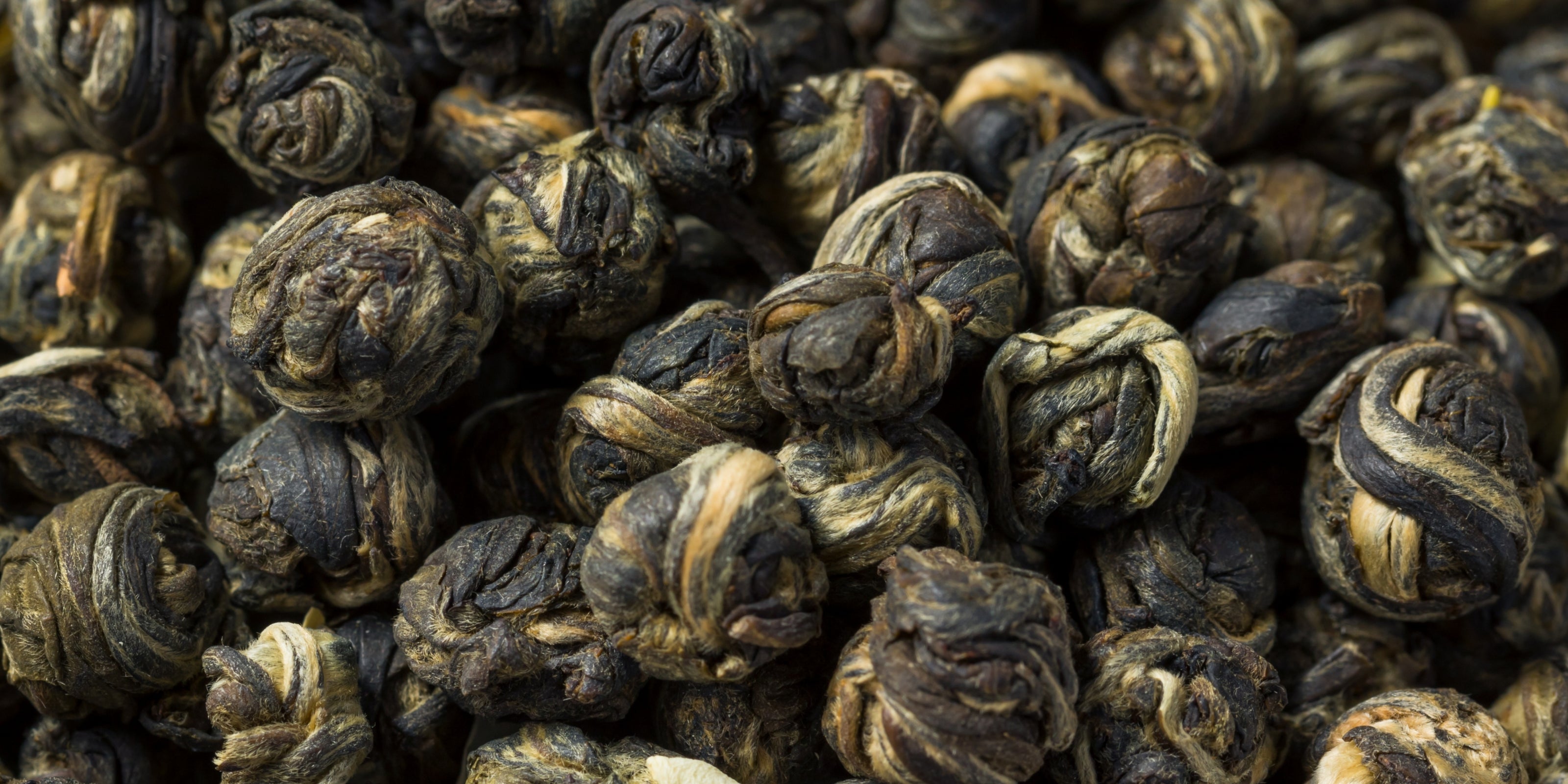 Close-up of rolled dried green tea leaves
