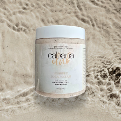Jar of Cabana Girl whipped sugar scrub on a textured beige background