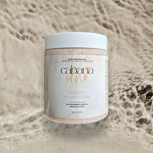 Jar of Cabana Girl whipped sugar scrub on a textured beige background