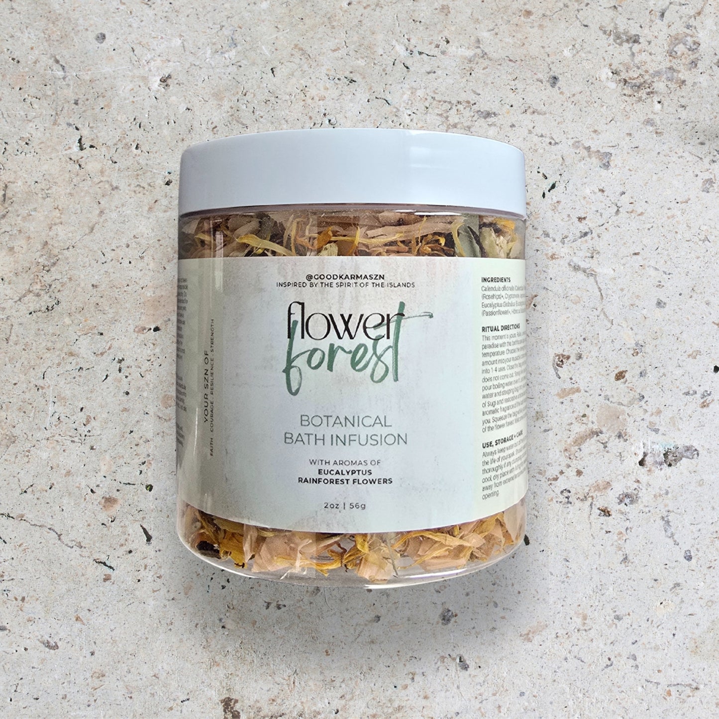 Jar of 'Flower Forest' botanical bath infusion on a textured surface