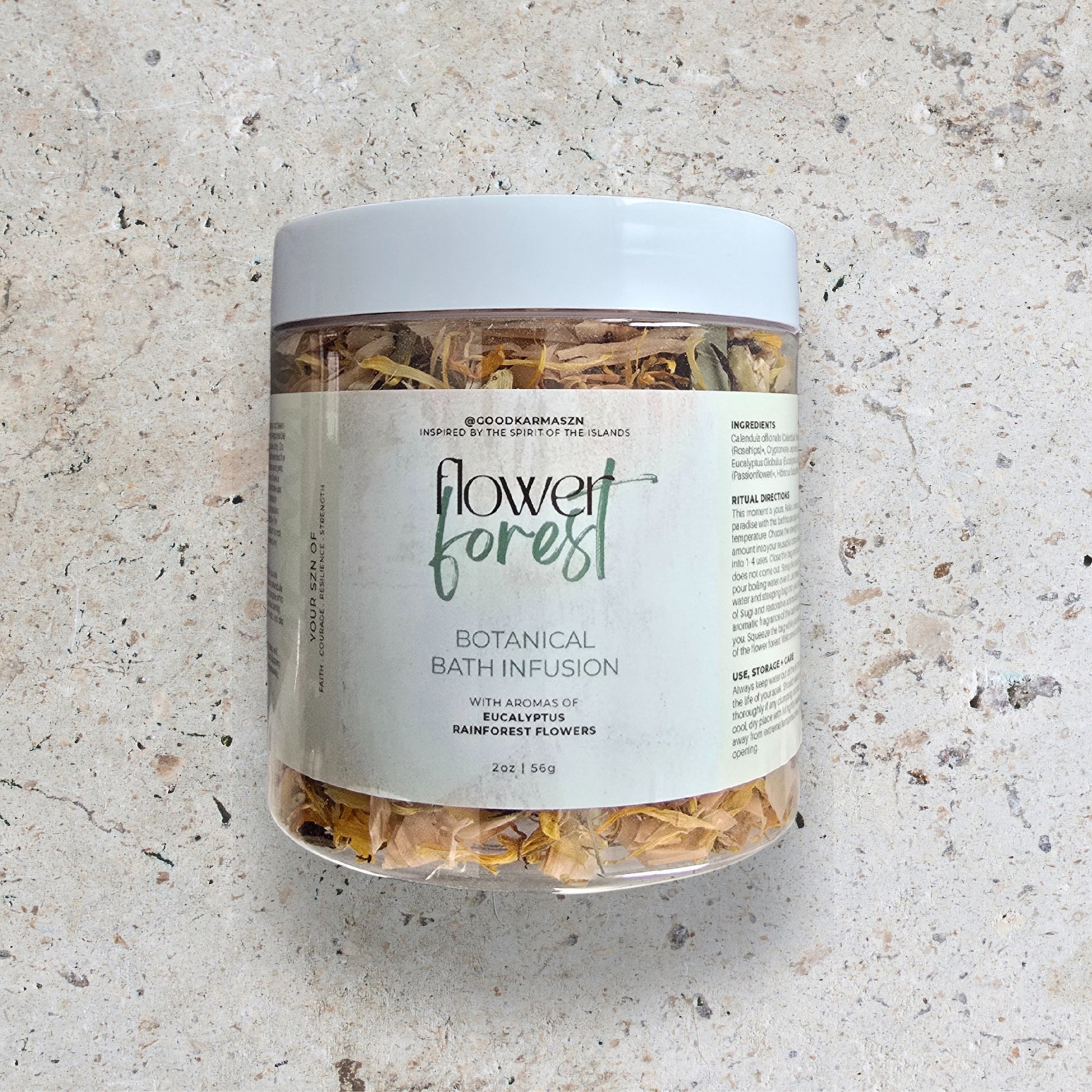 Jar of 'Flower Forest' botanical bath infusion on a textured surface