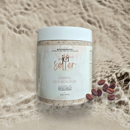 Jar of coffee sugar scrub with coffee beans on a sandy background