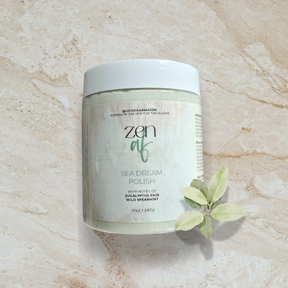 Jar of 'zen af' Sea Dream Polish on a marble surface with a eucalyptus leaf.