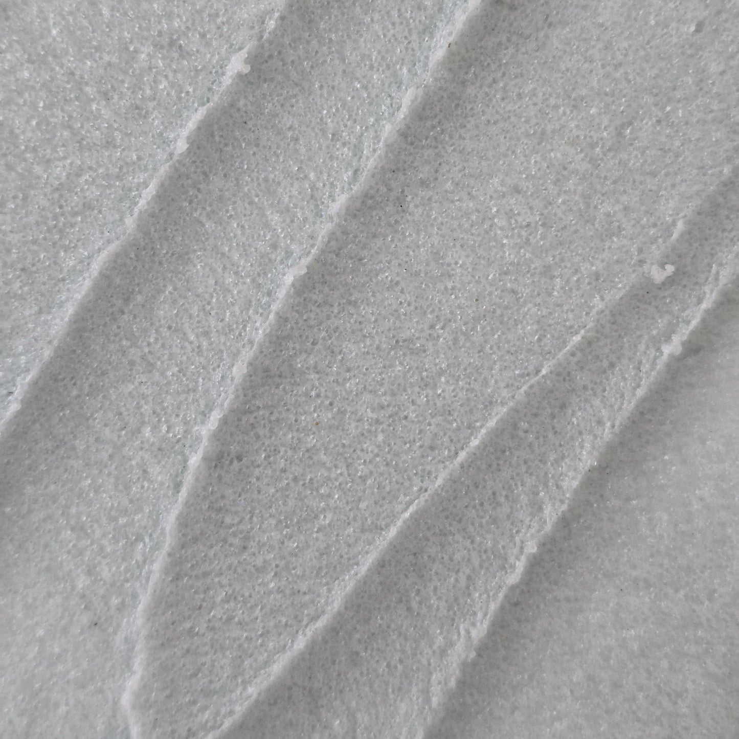 Close up of whipped light blue whipped sugar scrub texture 