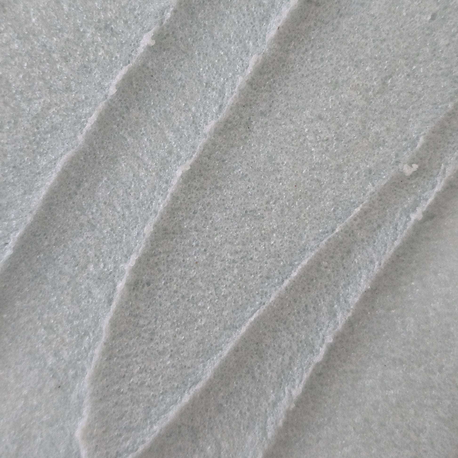 Close up of whipped light blue whipped sugar scrub texture 