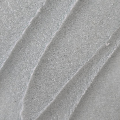 Close up of whipped light blue whipped sugar scrub texture 