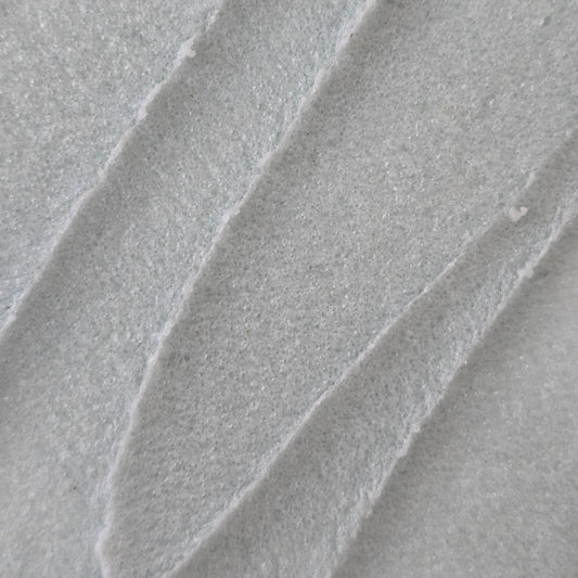 Close up of whipped light blue whipped sugar scrub texture 